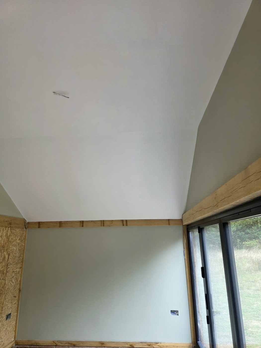 Boarded and skimmed ceiling above a new sliding door