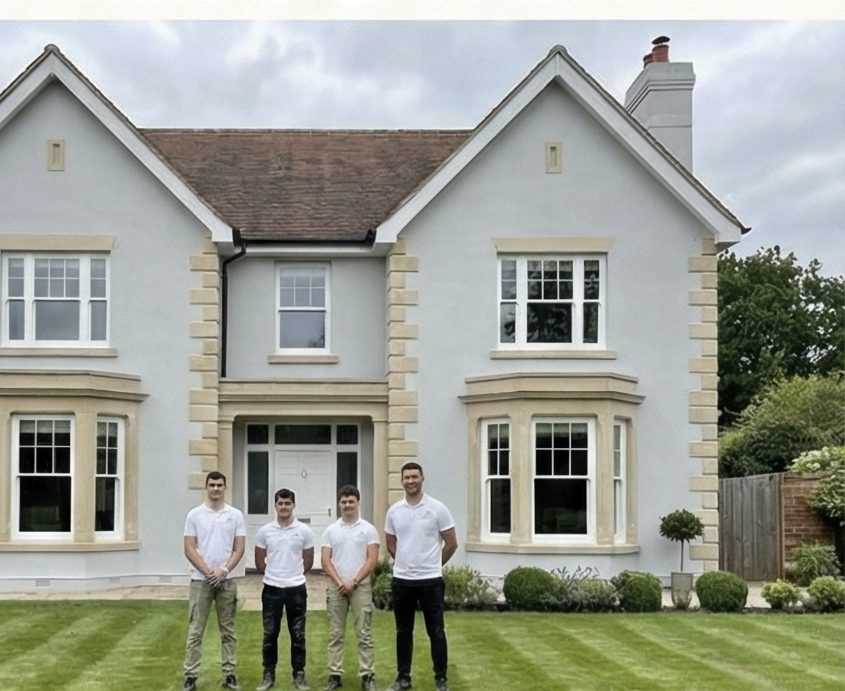 The team outside a finished facade renovation