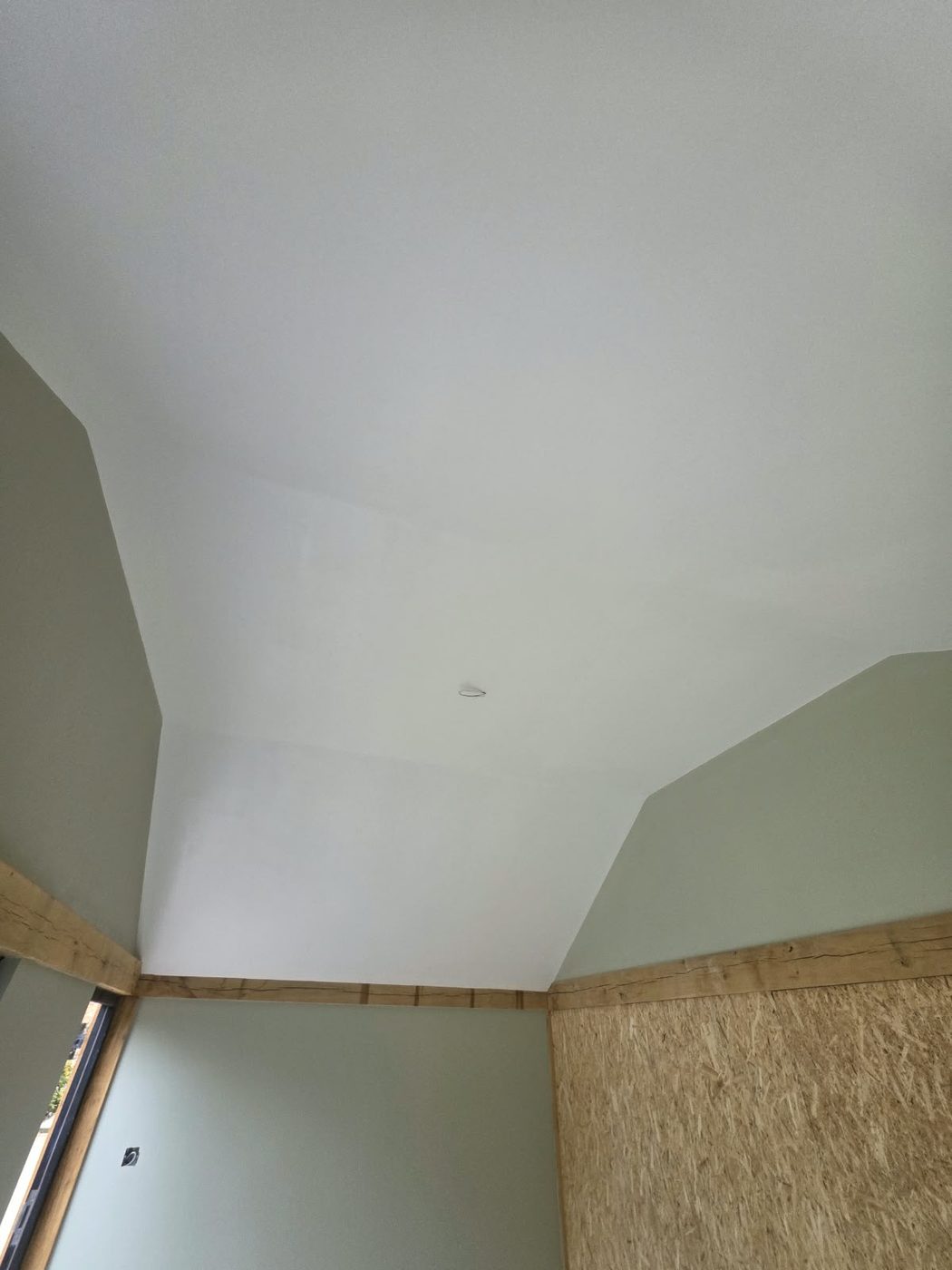 Vaulted ceiling skimmed and painted between oak beams